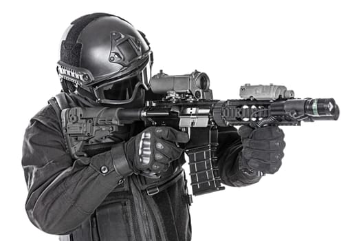 Spec ops police officer SWAT in black uniform and face mask studio shot