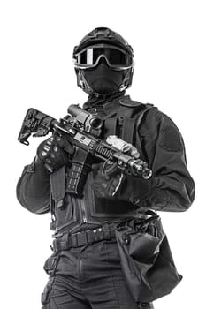 Spec ops police officer SWAT in black uniform and face mask studio shot