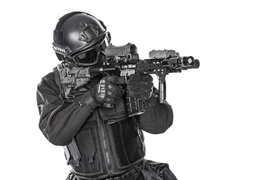 Spec ops police officer SWAT in black uniform and face mask studio shot