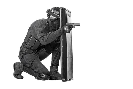 Spec ops police officer SWAT with ballistic shield studio shot