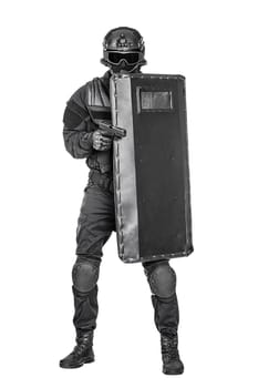 Spec ops police officer SWAT with ballistic shield studio shot