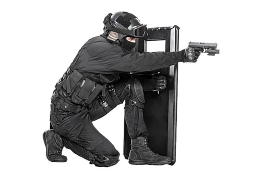 Spec ops police officer SWAT with ballistic shield studio shot