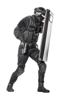 Spec ops police officer SWAT with ballistic shield studio shot