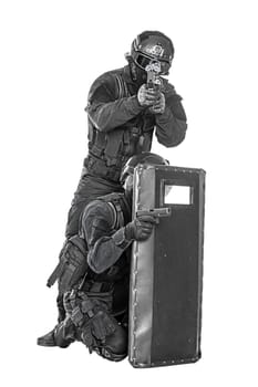 Spec ops police officer SWAT with ballistic shield studio shot