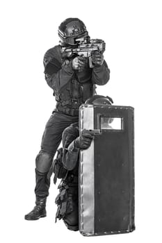 Spec ops police officer SWAT with ballistic shield studio shot
