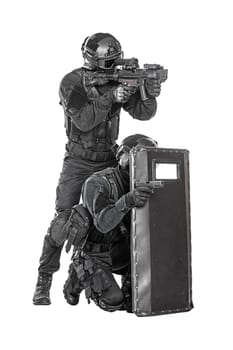 Spec ops police officer SWAT with ballistic shield studio shot