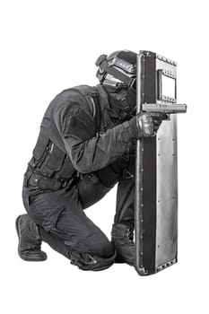 Spec ops police officer SWAT with ballistic shield studio shot