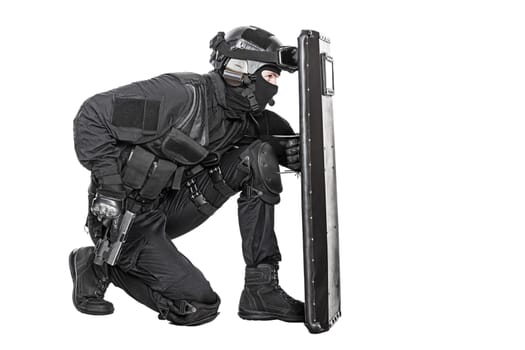Spec ops police officer SWAT with ballistic shield studio shot