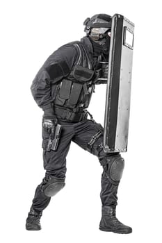 Spec ops police officer SWAT with ballistic shield studio shot