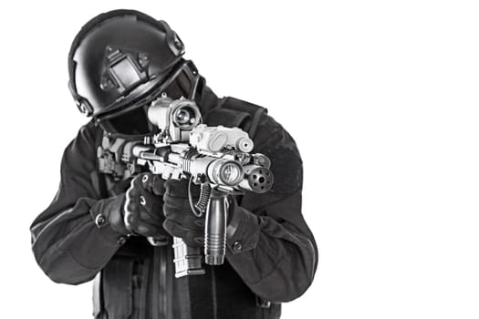Spec ops police officer SWAT in black uniform and face mask studio shot