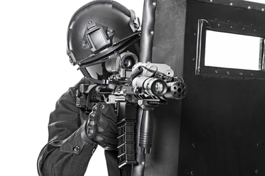 Spec ops police officer SWAT with ballistic shield studio shot