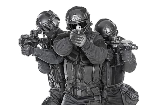 Spec ops police officers SWAT in black uniform and face mask studio shot