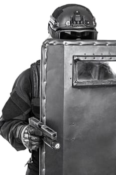 Spec ops police officer SWAT with ballistic shield studio shot