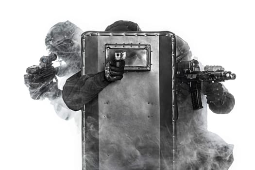 Police officers SWAT with ballistic shield in the smoke studio shot