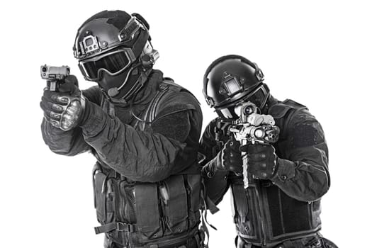 Spec ops police officers SWAT in black uniform and face mask studio shot