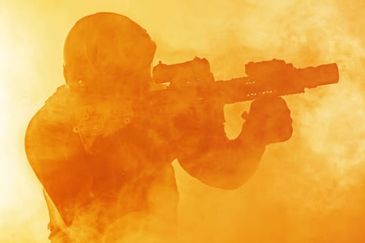 Police officer SWAT in black uniform in the smoke studio shot