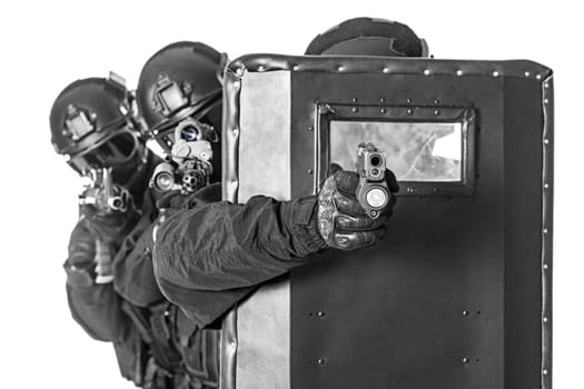 Spec ops police officers SWAT with ballistic shield studio shot
