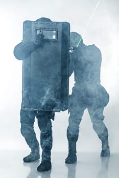 Police officers SWAT with ballistic shield in the smoke studio shot