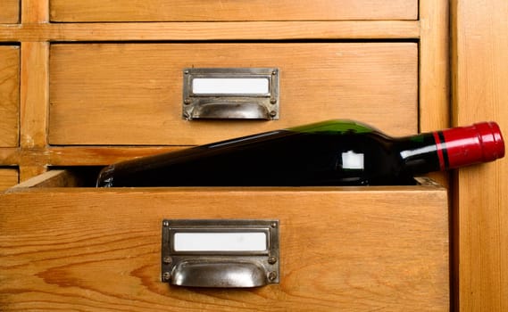 bottle of red wine in a drawer