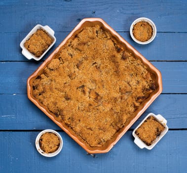 apple crumble on a blue wooden table
