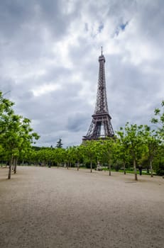 Eiffel Tower with trees and walkway  in the foreground