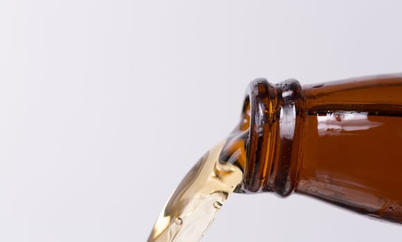 Beer Pouring From Bottle close up.
