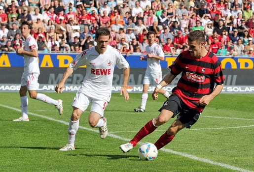 Daniel Caligiuri (right) scored in THE 4-1 win at SC Freiburg,where he is chased by ex-Freiburger Sascha Riether
