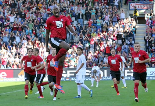 High,higher,highest,Karim Guede celebrates scoring and equalising Freiburg against Hoffenheim