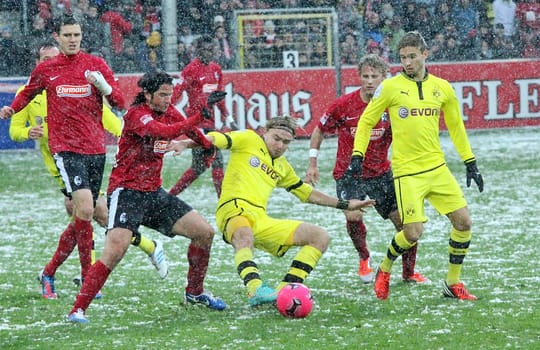 Full commitment: Marcel Schmelzer claims the ball against Freiburg's Terrazzino