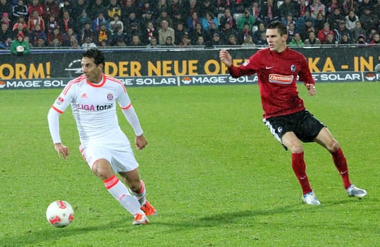 Claudio Pizzaro (left) is pursued by Johannes Flum