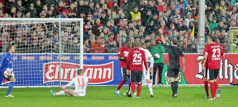 Referee Florian Meyer shows Fallou Diagne of SC Freiburg the red card after emergency brake