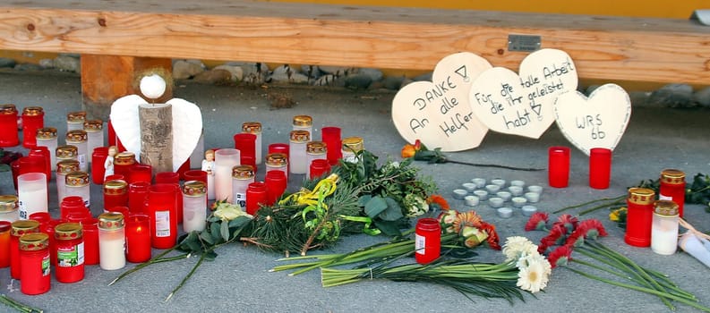 Candles,flowers and a few small farewell lines commemorate the 14 dead of the Titisee-Neustadt fire disaster in front of the workshop for the disabled