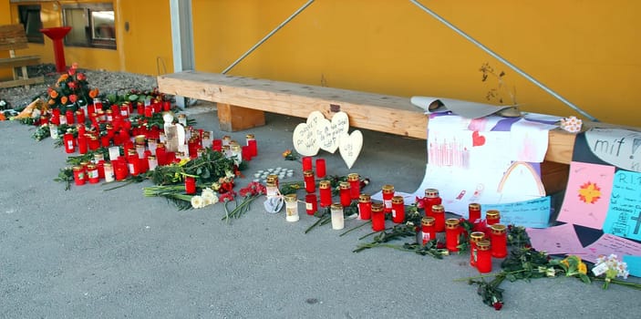 Wreaths with white ribbons take hold of last Monday's fire in Titisee-Neustadt. Fourteen people were killed in the workshop for the disabled. Candles,flowers and farewell letters at the Caritas workshop for the disabled