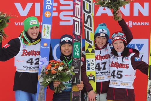 Sara Takanashi of Japan (centre) won the World Cup in women's ski jumping on 5.1.13 in Schonach. The Italierin Evelyn Insam (left) came in second place. Third place went to Austrian Daniela Iraschko