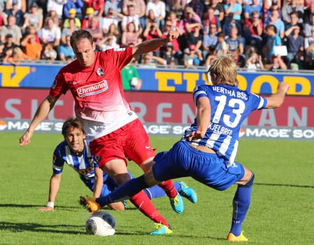 In this scene,Sebastian Freis from Freiburg is stopped by Berlin's Per Ciljan Skjelbred. 1. Bundesliga: 6. Sptgt. SC Freiburg vs. Hertha BSC Berlin