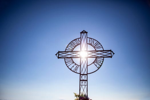 Cross with mountains over blue sky and hills on the background, Tentudia, Spain