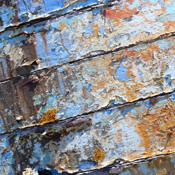 Boards of old boat with peeling paint background texture