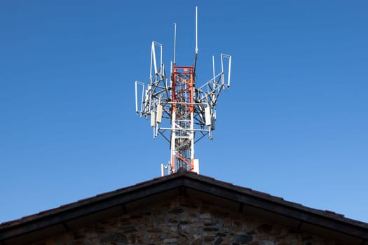 Mobile phone Telecommunication Radio antenna Tower over blue sky