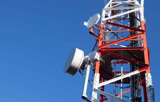 Mobile phone Telecommunication Radio antenna Tower over blue sky