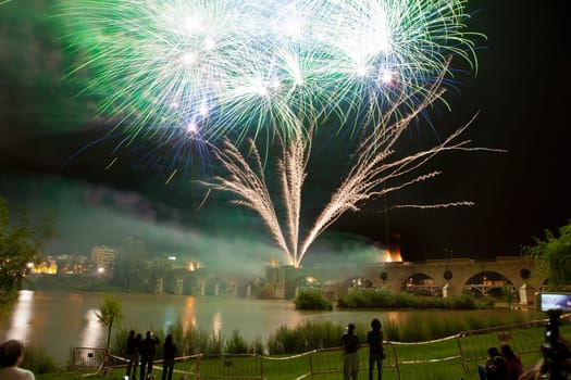 Colorful fireworks shot from Puente de Palmas bridge at Badajoz, Spain, during the San Juan festivity night