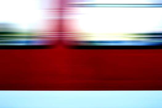 The abstract and colorful motion strips of the windows of a passing train.