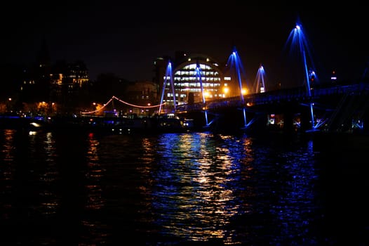 London,Uk – November 29,2014: The nightlit Hungerford Bridge over the River Thames with Charing Cross station on 29 November 2014 in London.
