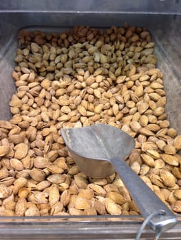 Box with almonds on market with shovel for serve yourself