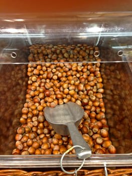 Box with hazelnut on market with shovel for serve yourself
