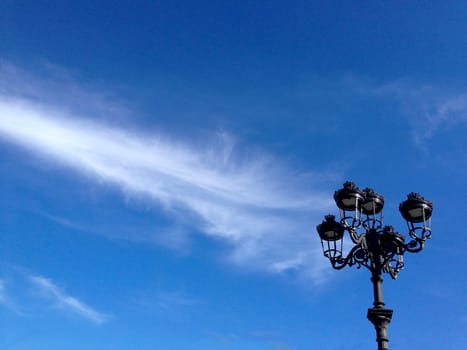 Old fashioned street light against a blue Sky. Downtown, Spain