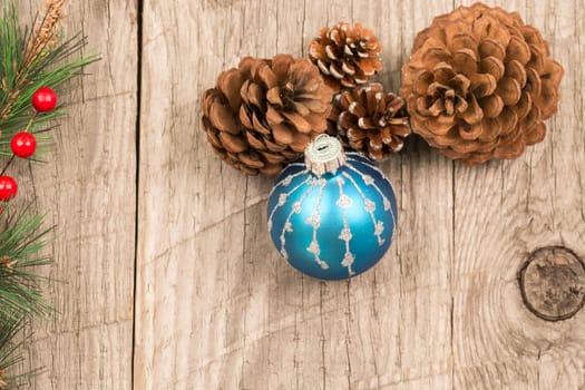 Christmas baubles and pine cones top view