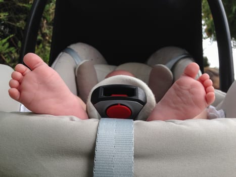 One month age baby feet at maxi cosi baby seat