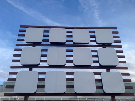Empty big billboard at shopping mall, isolated over blue sky