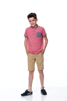 Young male dressed in casual clothing with a white background. he is looking at the camera and smiling.