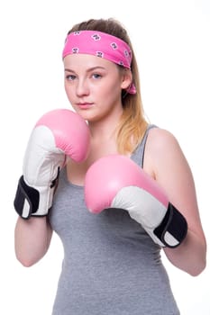 Portrait of a strong and fearless young woman wearing boxing gloves on a white background